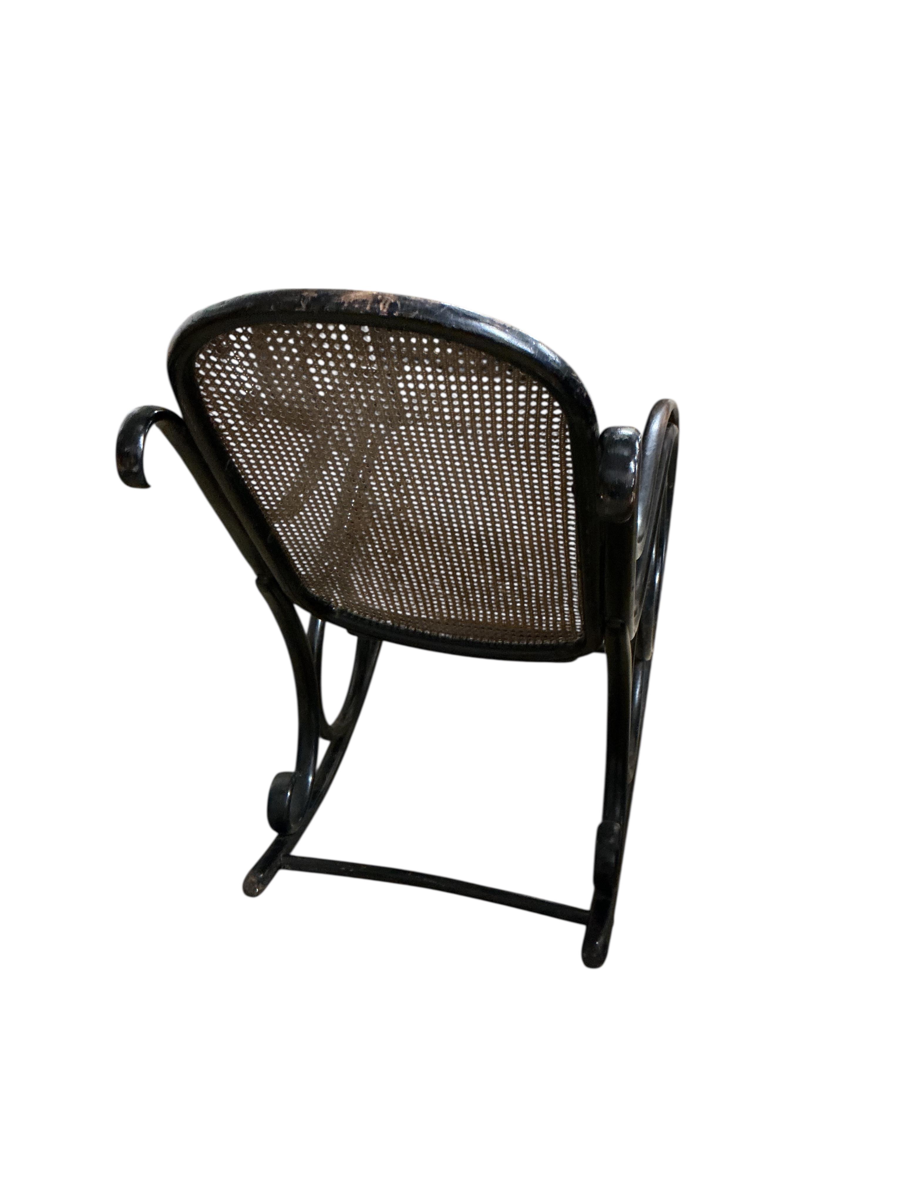 A Thonet ebonised bentwood rocking chair, width 54cm, depth 100cm, height 98cm